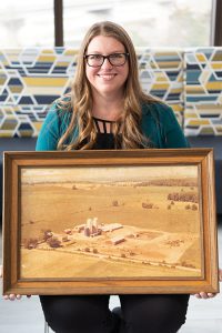 Tiffany with a photo of the farm